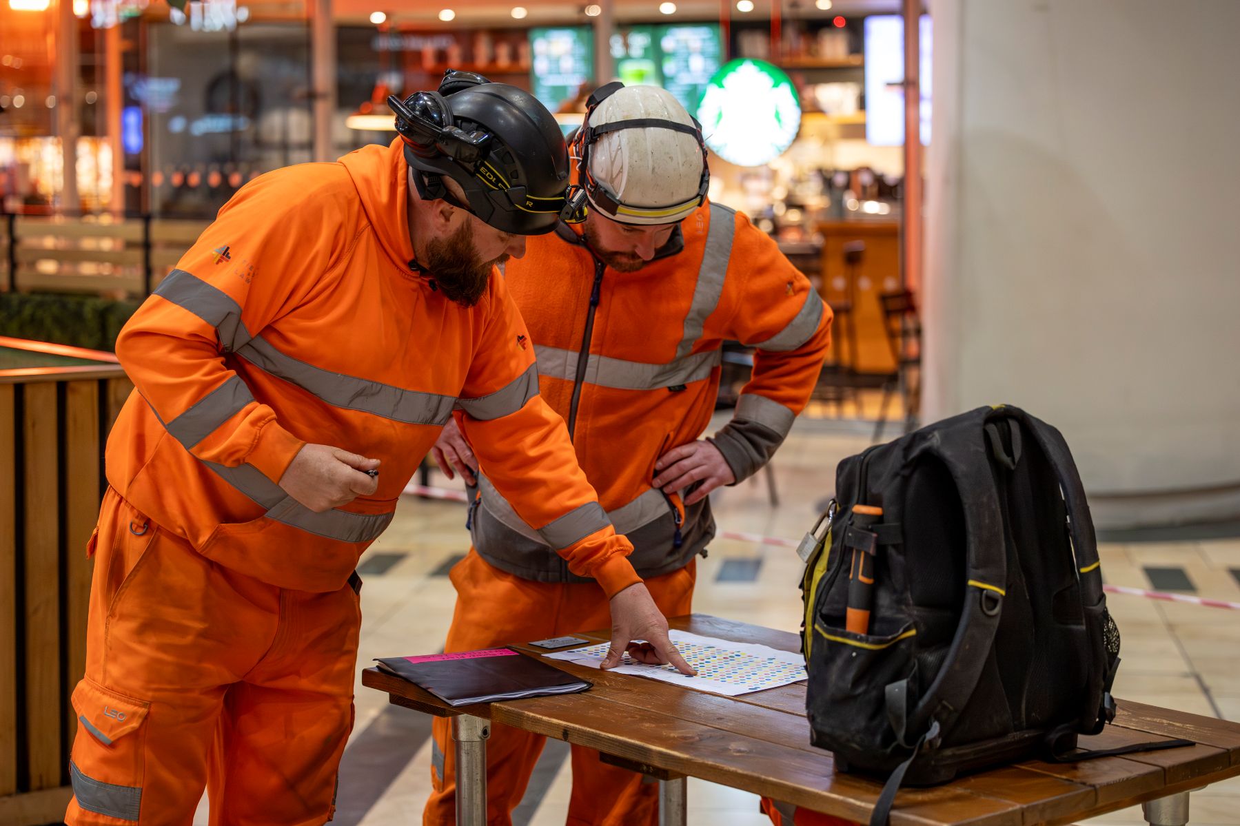 a team installing umbrella artwork at a shopping centre